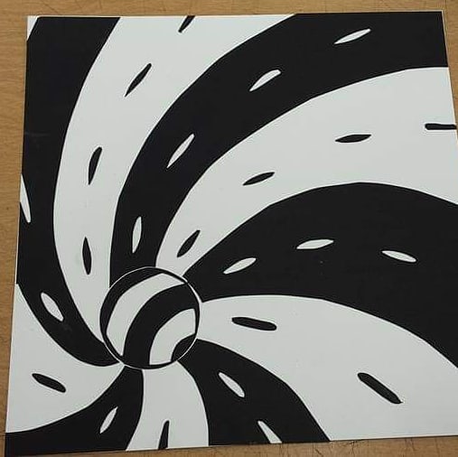 Black and white striped ball looks like it's spiraling down with lines swirling away from it