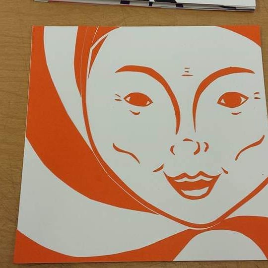 Woman created with basic orange linework with spirals in the background